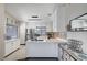 Modern kitchen featuring white cabinets, stainless steel appliances, and stylish backsplash at 1708 Anzio St, Las Vegas, NV 89108