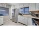 Bright kitchen with stainless appliances, custom backsplash and white cabinetry at 1708 Anzio St, Las Vegas, NV 89108