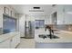 Bright kitchen with stainless steel appliances, white cabinetry and stone countertops at 1708 Anzio St, Las Vegas, NV 89108