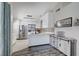 Modern kitchen featuring sleek white cabinets, stainless steel appliances, and a stylish backsplash at 1708 Anzio St, Las Vegas, NV 89108