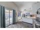 Bright kitchen with stainless steel appliances, white cabinetry and breakfast bar near sliding glass door at 1708 Anzio St, Las Vegas, NV 89108