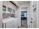 Modern laundry room with overhead cabinets and washer and dryer hookups at 1708 Anzio St, Las Vegas, NV 89108