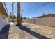 Long backyard with a tall privacy wall, house, and mature trees at 2005 Jansen Ave, Las Vegas, NV 89101