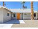 Close up shot of a well-maintained single-story home with an inviting orange front door at 2005 Jansen Ave, Las Vegas, NV 89101