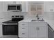 Close-up of the kitchen with stainless steel appliances, quartz countertops, and modern white cabinetry at 2005 Jansen Ave, Las Vegas, NV 89101