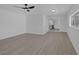 Open-concept living room with view to kitchen, modern fan, and light wood floors at 2005 Jansen Ave, Las Vegas, NV 89101