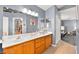 Bright bathroom featuring double sinks, a large mirror, and wood cabinets at 262 Cielito Lindo St, Henderson, NV 89012