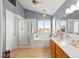 Bathroom with separate shower, soaking tub, and dual sink vanity with wood cabinets at 262 Cielito Lindo St, Henderson, NV 89012
