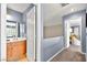 Hallway with view of a bathroom with wooden vanity and access to a bedroom at 262 Cielito Lindo St, Henderson, NV 89012