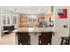 Well-lit kitchen featuring granite countertops, stainless steel appliances, and a central island with seating at 262 Cielito Lindo St, Henderson, NV 89012
