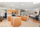 Open kitchen with island, stainless appliances, and light wood cabinets flowing into a comfortable living area at 262 Cielito Lindo St, Henderson, NV 89012