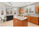 Bright kitchen featuring light wood cabinets, stainless steel appliances, granite countertops, and shuttered windows at 262 Cielito Lindo St, Henderson, NV 89012