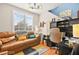 Cozy office features a brown couch, desk, shelving and modern lighting at 262 Cielito Lindo St, Henderson, NV 89012