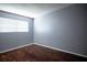 Simple bedroom features gray walls, wood floors, a window, and minimal trim at 2721 Merritt Ave, Las Vegas, NV 89102