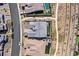 Aerial view of a well-maintained home with a gray roof, green backyard, and a paved walkway near a community trail at 2931 Raywood Ash Dr, Las Vegas, NV 89138