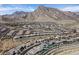 Expansive aerial view of a Primary-planned community nestled against a dramatic mountain backdrop at 2931 Raywood Ash Dr, Las Vegas, NV 89138