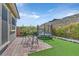 Landscaped backyard with brick paver patio, trampoline, seating, and view of hillside at 2931 Raywood Ash Dr, Las Vegas, NV 89138