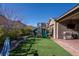 Backyard featuring a playset, artificial grass, covered patio, and outdoor grill at 2931 Raywood Ash Dr, Las Vegas, NV 89138