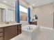 Elegant bathroom with a large soaking tub, double sinks, and granite countertops at 2931 Raywood Ash Dr, Las Vegas, NV 89138