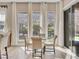 Cozy breakfast nook with a glass table and comfortable seating near large windows at 2931 Raywood Ash Dr, Las Vegas, NV 89138