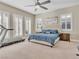 Serene main bedroom features a ceiling fan, multiple windows, and a comfortable bed at 2931 Raywood Ash Dr, Las Vegas, NV 89138