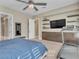 Spacious main bedroom with a ceiling fan, a wall-mounted TV, and a treadmill at 2931 Raywood Ash Dr, Las Vegas, NV 89138