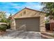 Two-car garage and landscaping features a low-maintenance design at 3005 Dotted Wren Ave, North Las Vegas, NV 89084