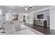 Spacious living area with hardwood floors, large sectional, and media console at 3005 Dotted Wren Ave, North Las Vegas, NV 89084