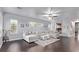 Spacious living room with large sectional sofa, hardwood floors, and plenty of natural light at 3005 Dotted Wren Ave, North Las Vegas, NV 89084