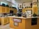 Bright kitchen featuring classic yellow cabinetry, white countertops, and plenty of decorative elements at 3028 Ripon Dr, Las Vegas, NV 89134