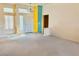 Spacious living room featuring plush carpet flooring, neutral walls, and an entry door with stained glass windows at 3028 Ripon Dr, Las Vegas, NV 89134