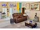 Inviting living room with plush seating, carpet flooring, bright walls, and decorative stained glass windows at 3028 Ripon Dr, Las Vegas, NV 89134