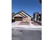 A well-kept single-story home featuring a two-car garage and landscaped front yard at 3078 Kennewick Dr, Las Vegas, NV 89121