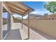A covered patio with a concrete walkway provides a peaceful retreat in the backyard at 3101 Greenbriar Dr, Las Vegas, NV 89121