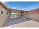Spacious backyard patio area featuring a built-in grill and ample seating under a shaded cover at 3101 Greenbriar Dr, Las Vegas, NV 89121
