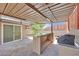 Outdoor covered patio featuring built in grill and bar, with access to the home via glass slider at 3101 Greenbriar Dr, Las Vegas, NV 89121