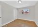 Bright bedroom featuring hardwood floors, a window providing natural light and double sliding closet at 3101 Greenbriar Dr, Las Vegas, NV 89121