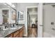 Bathroom featuring a granite countertop, single sink, a large mirror, and shower at 3145 E Flamingo Rd # 1045, Las Vegas, NV 89121