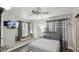 Bedroom with ceiling fan, mirrored closet, and window seat at 3145 E Flamingo Rd # 1045, Las Vegas, NV 89121