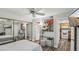 Cozy bedroom with ceiling fan, mirrored closet doors, and view into a kitchen at 3145 E Flamingo Rd # 1045, Las Vegas, NV 89121
