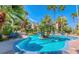Stunning community pool area with lush landscaping and comfortable lounge chairs, creating a perfect spot for relaxation at 3145 E Flamingo Rd # 1045, Las Vegas, NV 89121
