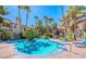 Sparkling community pool with clear blue water, surrounded by palm trees, creating a serene atmosphere for residents at 3145 E Flamingo Rd # 1045, Las Vegas, NV 89121