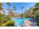 Resort-style community pool surrounded by lush landscaping and towering palm trees, creating a relaxing oasis at 3145 E Flamingo Rd # 1045, Las Vegas, NV 89121