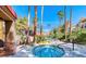 Inviting hot tub area featuring a stone surround, perfect for relaxation among the lush, tropical landscaping at 3145 E Flamingo Rd # 1045, Las Vegas, NV 89121