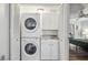 Closet featuring stacked washer and dryer, providing a compact laundry solution within the unit at 3145 E Flamingo Rd # 1045, Las Vegas, NV 89121