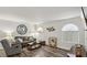 Cozy living room featuring modern furnishings, a large clock, and ample natural light at 3145 E Flamingo Rd # 1045, Las Vegas, NV 89121