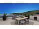 Outdoor dining with lake views and a built-in kitchen make this a relaxing space at 32 Heron Harbour Dr, Henderson, NV 89011