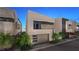 Contemporary home with clean lines, a three-car garage, well-maintained landscaping, and modern appeal at 32 Heron Harbour Dr, Henderson, NV 89011