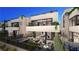 Stunning modern home with a large patio, outdoor seating, and a glimpse of the open-concept interior at 32 Heron Harbour Dr, Henderson, NV 89011