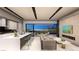 Open-concept living space with a modern kitchen, cozy seating area, fireplace, and scenic lake views at 32 Heron Harbour Dr, Henderson, NV 89011